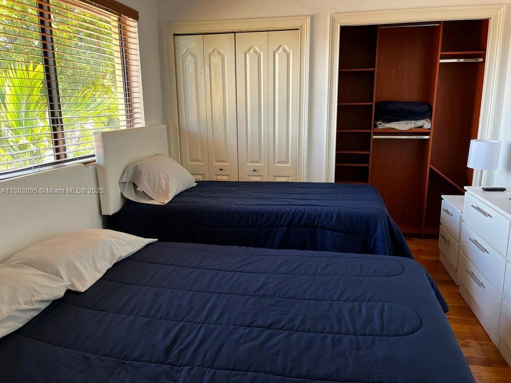 1411 Normandy Drive Miami Beach, FL 33141 - Photo 16 of 23 a bedroom with a bed and wooden floor