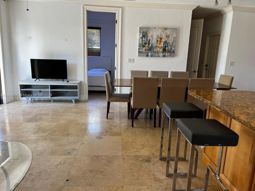 1411 Normandy Drive Miami Beach, FL 33141 - Photo 6 of 23 a view of a livingroom with furniture and a flat screen tv