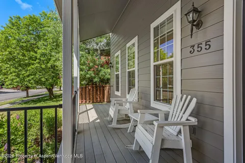 a view of deck with furniture and garden