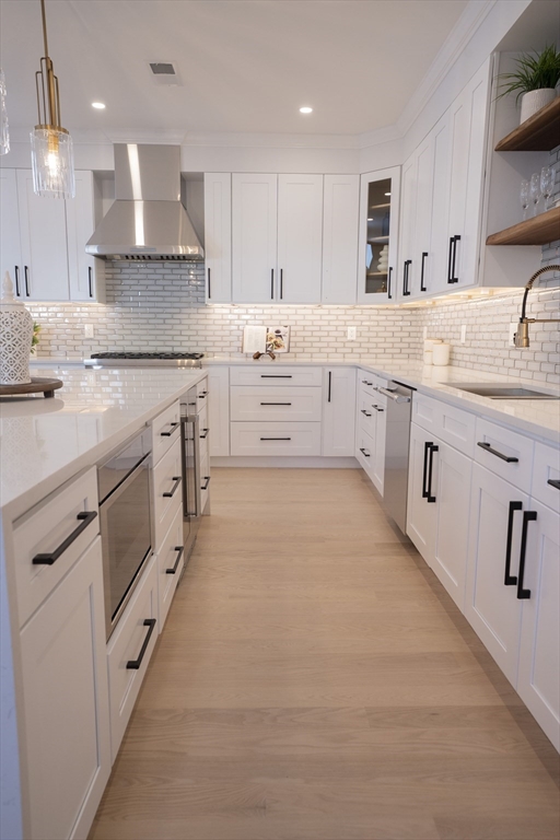 24 Palmetto Street Saugus, MA 01906 - Photo 20 of 37 a large white kitchen with cabinets