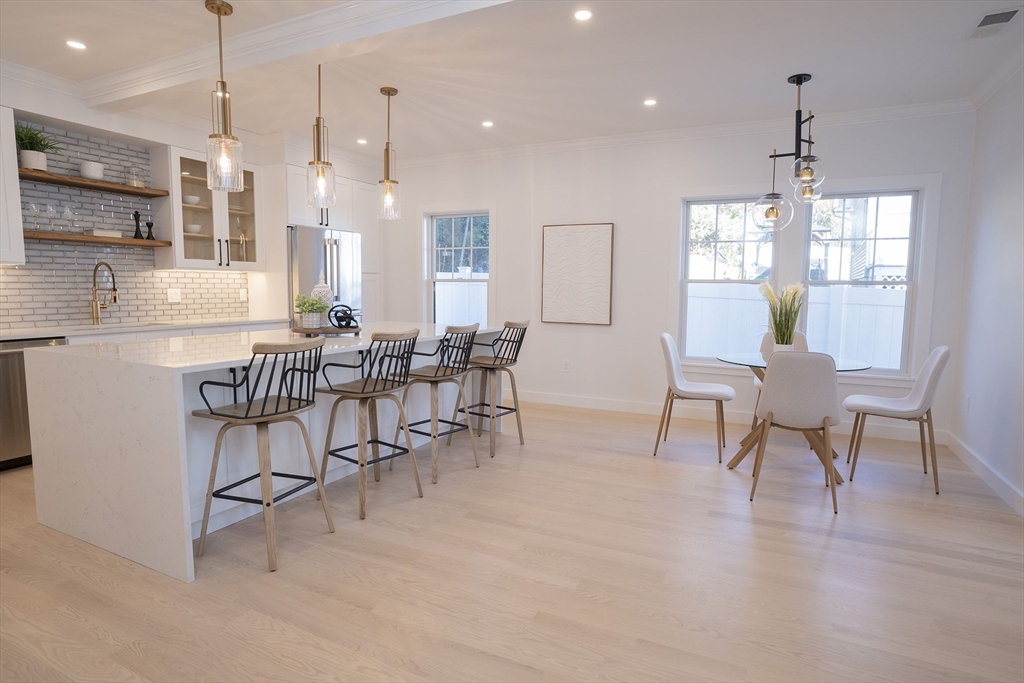 24 Palmetto Street Saugus, MA 01906 - Photo 21 of 37 a dining room with furniture a chandelier and wooden floor