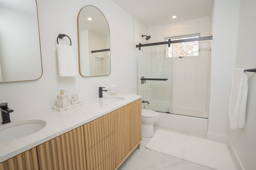 24 Palmetto Street Saugus, MA 01906 - Photo 31 of 37 a bathroom with a double vanity sink mirror and shower
