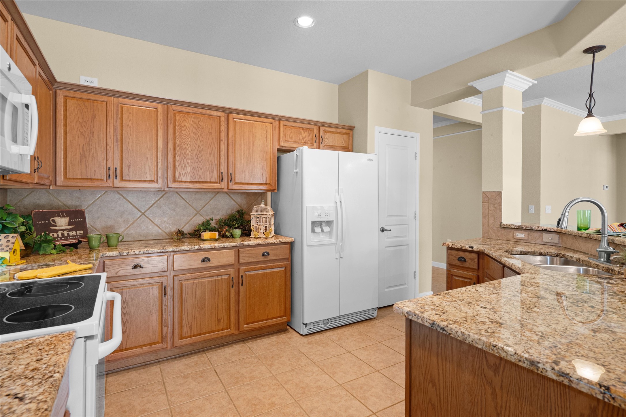 321 Yukon Terrace Georgetown, TX 78633 - Photo 3 of 15 a kitchen with stainless steel appliances granite countertop a stove a sink and a refrigerator