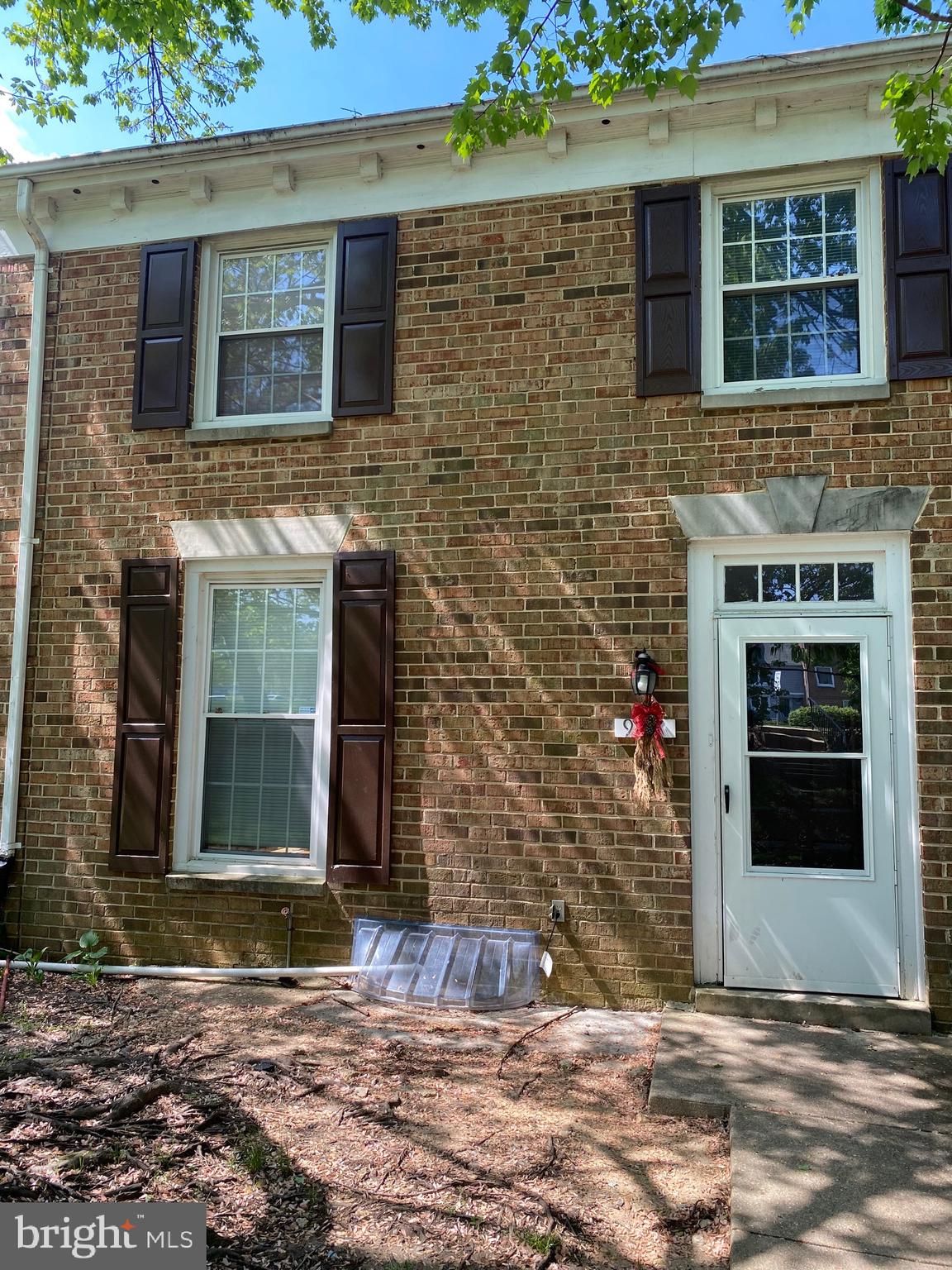 9717 Whiskey Run Laurel, MD 20723 - Photo 1 of 31 a view of a brick house with a door and a window