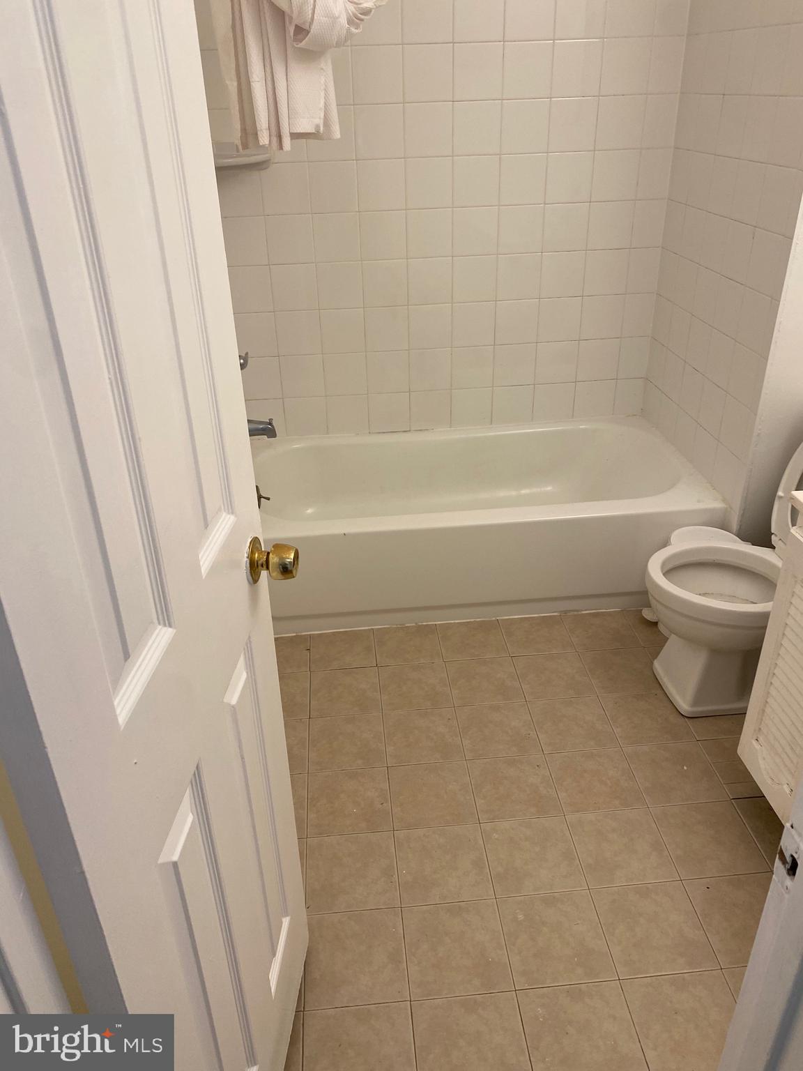 9717 Whiskey Run Laurel, MD 20723 - Photo 18 of 31 a bathroom with a toilet and a bath tub