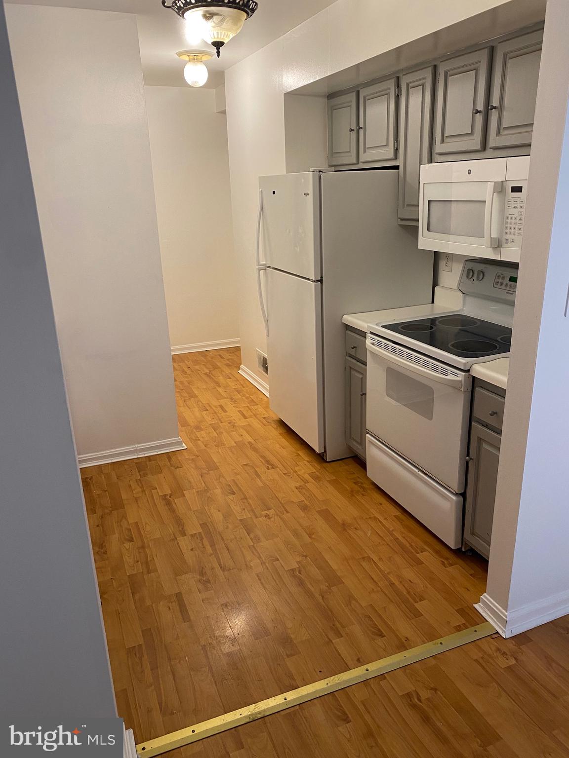9717 Whiskey Run Laurel, MD 20723 - Photo 4 of 31 a kitchen with stainless steel appliances a refrigerator and a stove