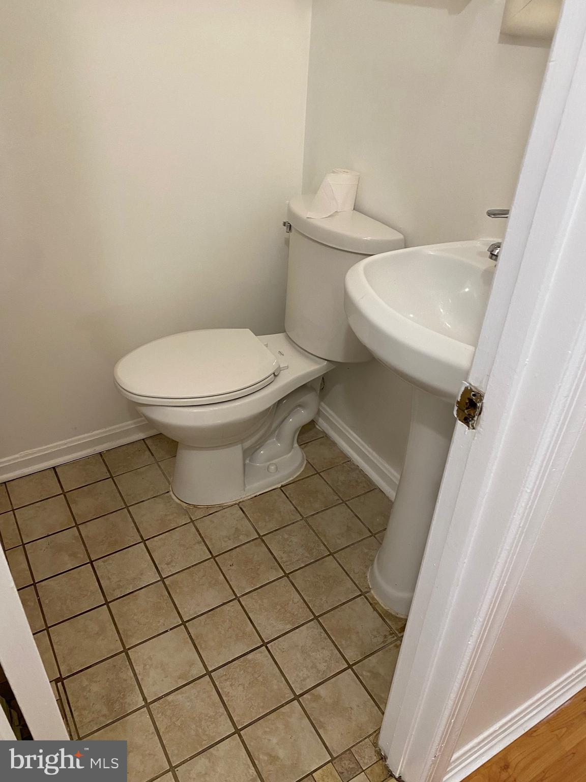 9717 Whiskey Run Laurel, MD 20723 - Photo 6 of 31 a white toilet sitting next to a white cabinet