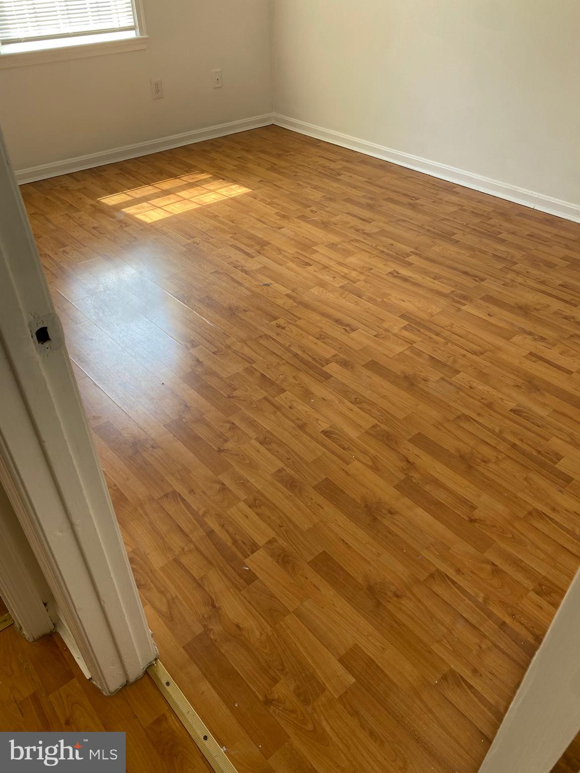 9717 Whiskey Run Laurel, MD 20723 - Photo 10 of 31 a view of empty room with wooden floor