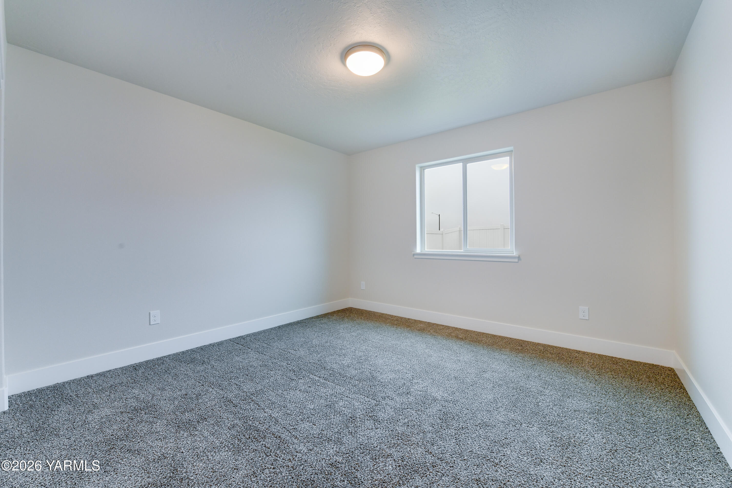 903 North Euclid Road, Unit PHASE 1 LOT 8) SPEC Grandview, WA 98930 - Photo 8 of 25 an empty room with a window