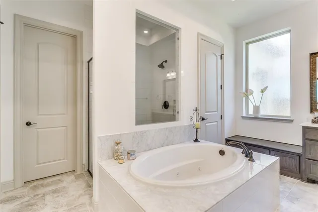 a bathroom with a tub sink and mirror