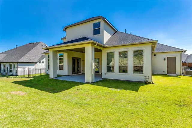 a front view of a house with yard and green space