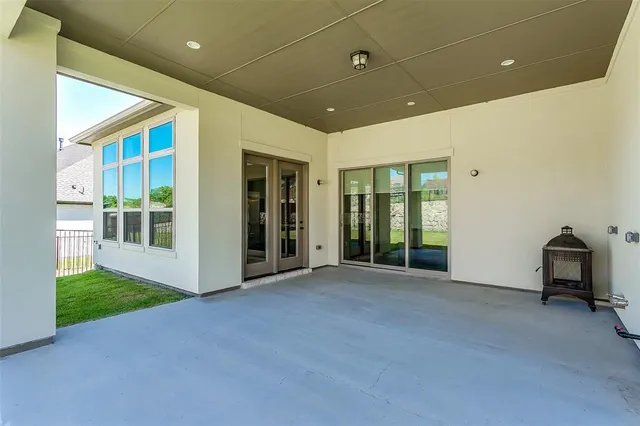 a view of an empty room with glass door and balcony