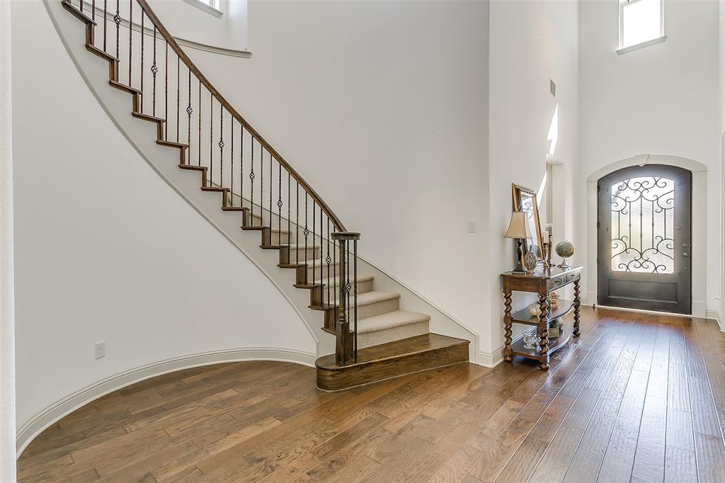 1636 Prairie Ridge Road Fort Worth, TX 76008 - Photo 3 of 14 a view of staircase with wooden floor and a chandelier