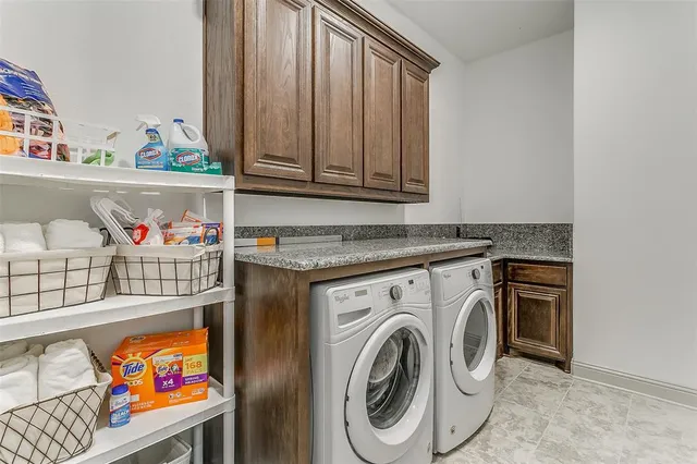a utility room with fridge and wooden floor
