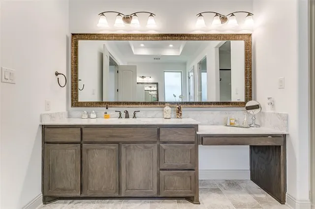 a bathroom with a double vanity sink and a mirror