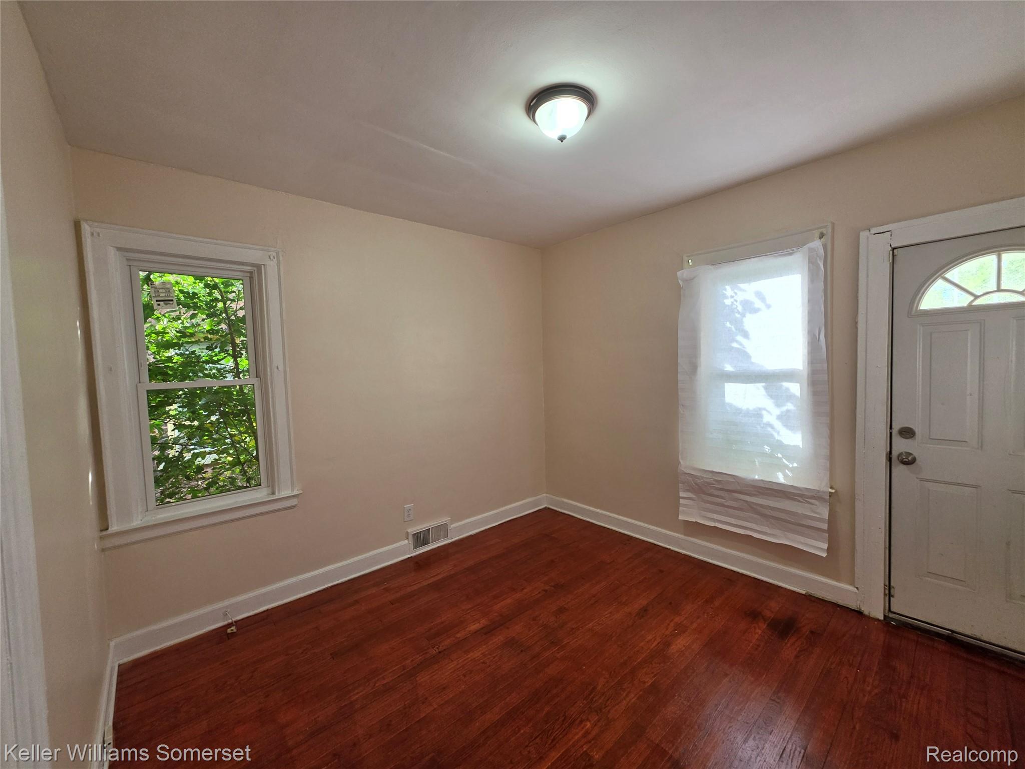 12609 Santa Rosa Drive Detroit, MI 48238 - Photo 10 of 11 Hardwood flooring, painted walls, white trim, recessed window, and a ceiling-mounted light fixture