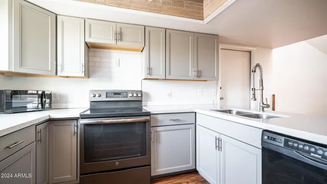 a kitchen with a sink stove and cabinets
