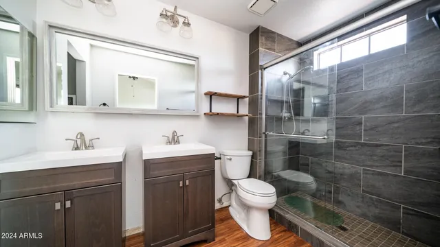 a bathroom with a toilet sink and mirror