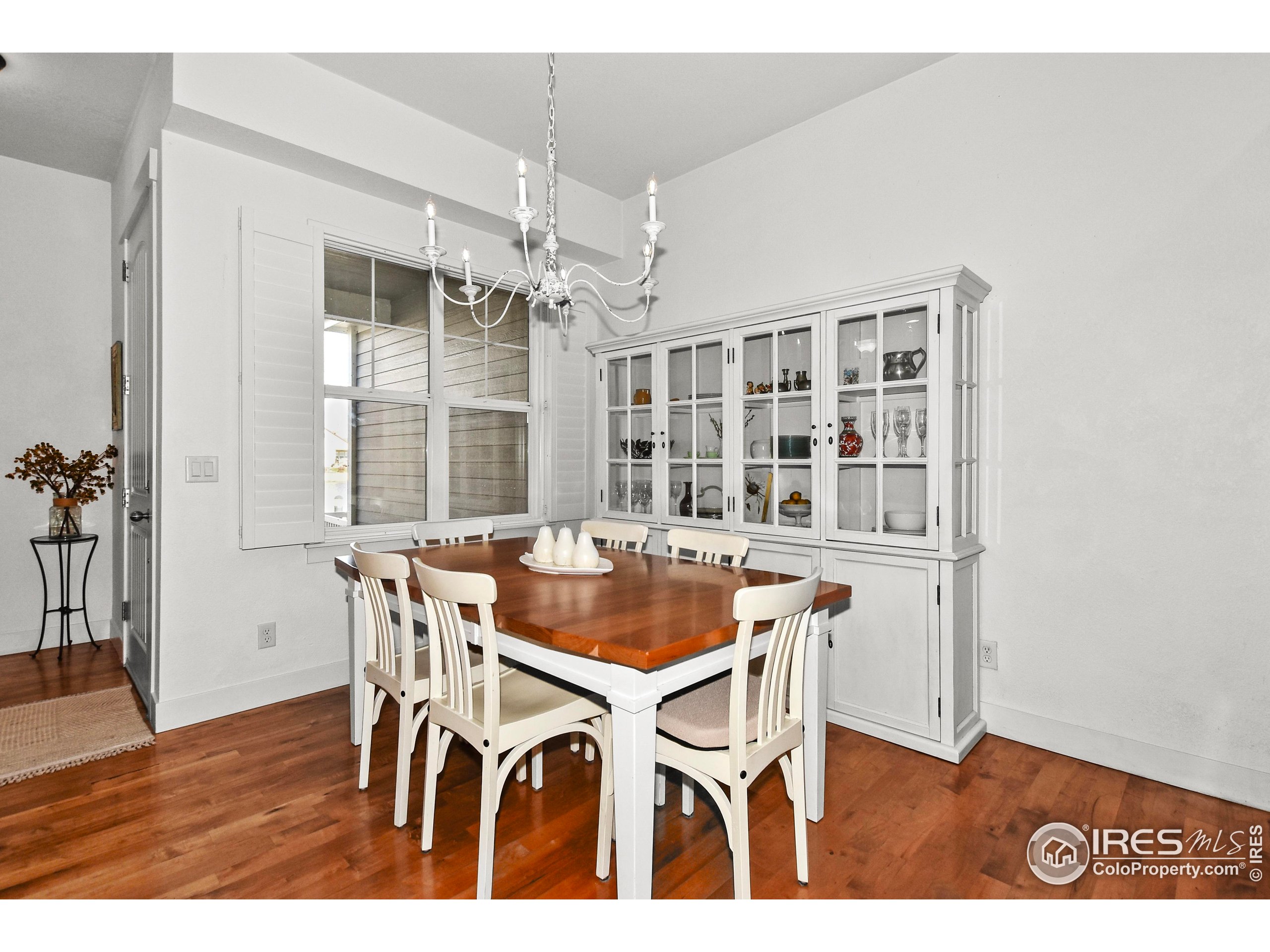 2172 Cape Hatteras Drive, Unit 2 Windsor, CO 80550 - Photo 11 of 46 a view of a dining room with furniture and wooden floor