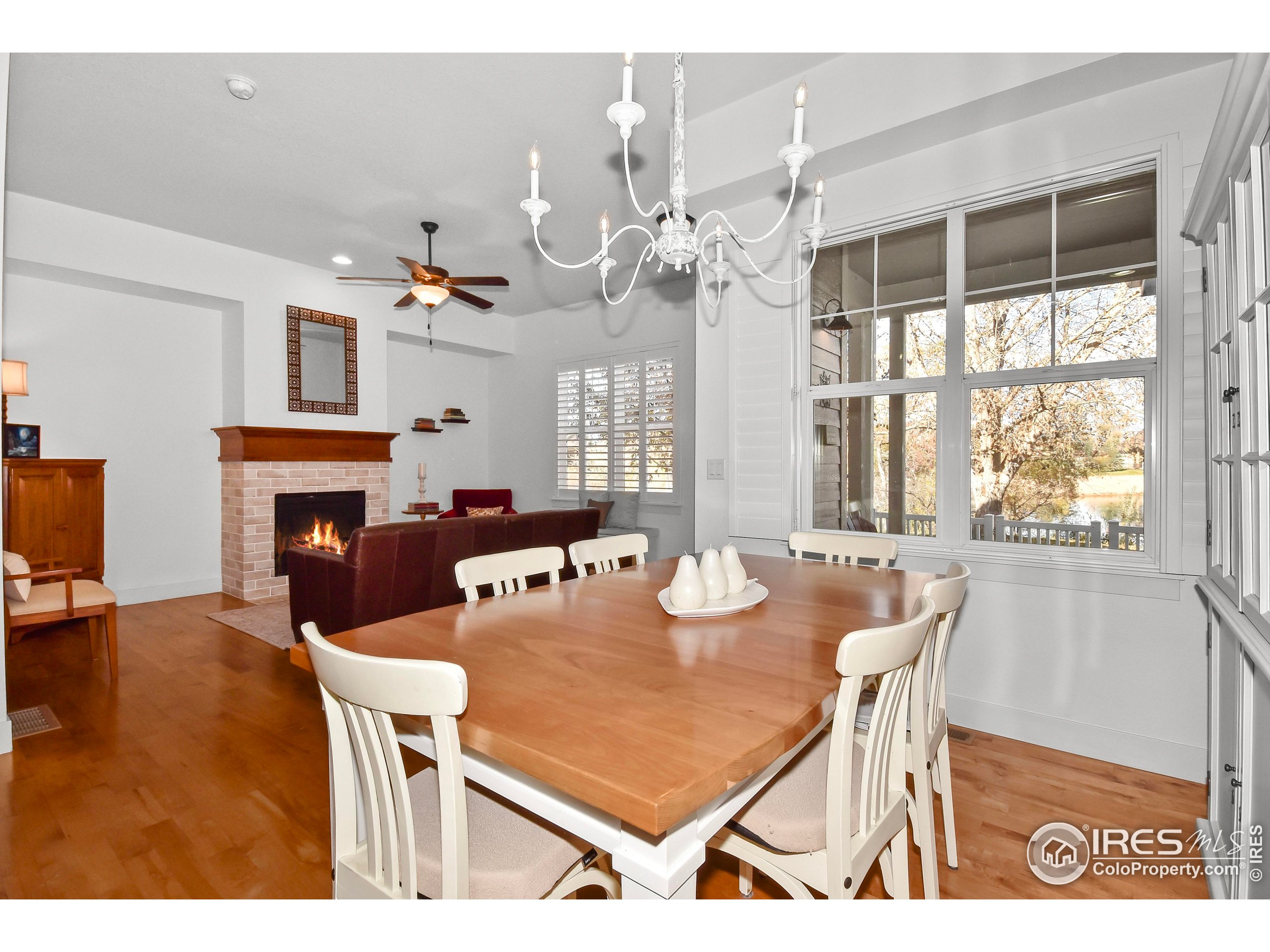 2172 Cape Hatteras Drive, Unit 2 Windsor, CO 80550 - Photo 14 of 46 a view of a dining room with furniture a chandelier and wooden floor