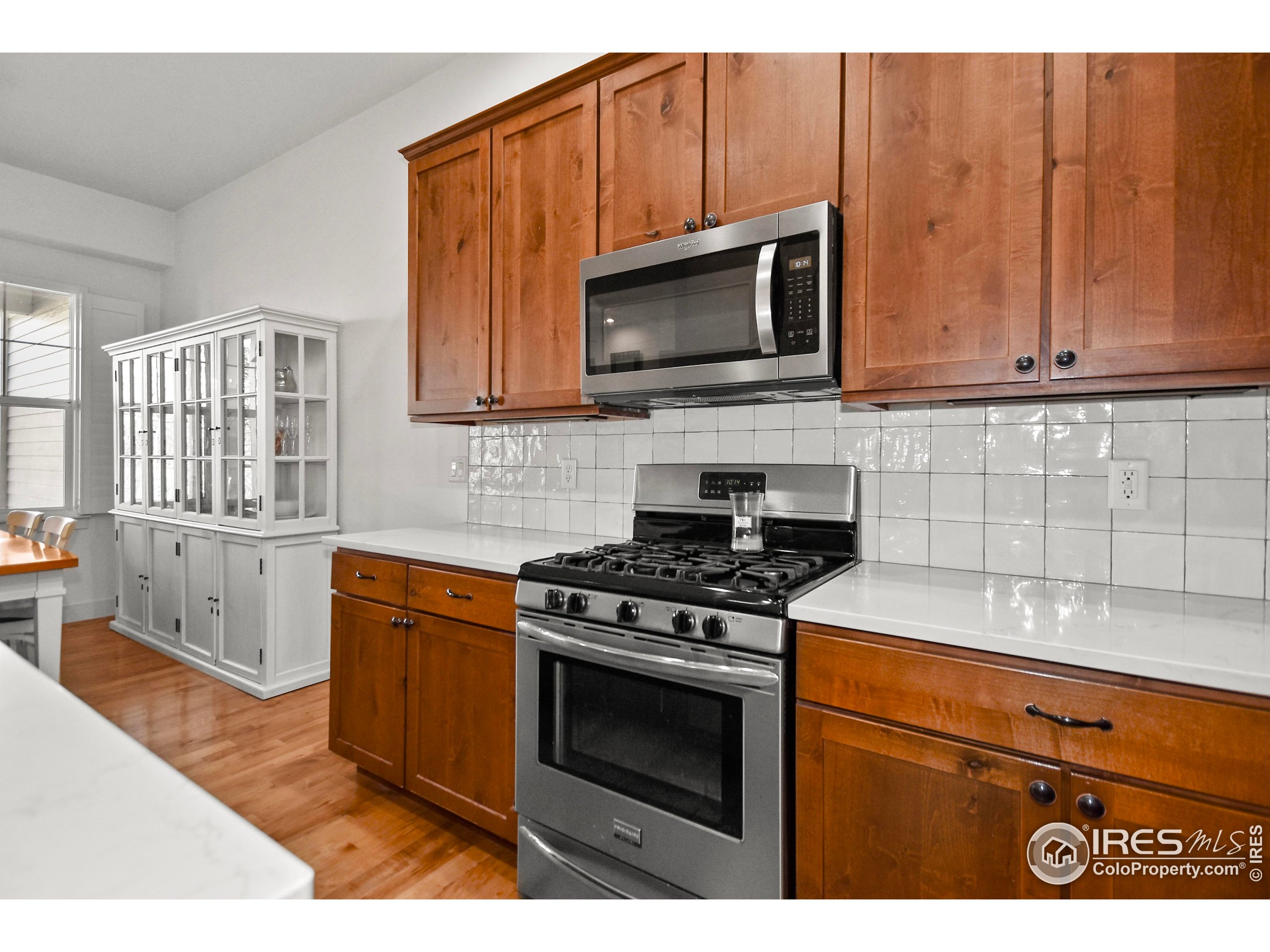 2172 Cape Hatteras Drive, Unit 2 Windsor, CO 80550 - Photo 18 of 46 a kitchen with stainless steel appliances granite countertop a stove microwave and sink