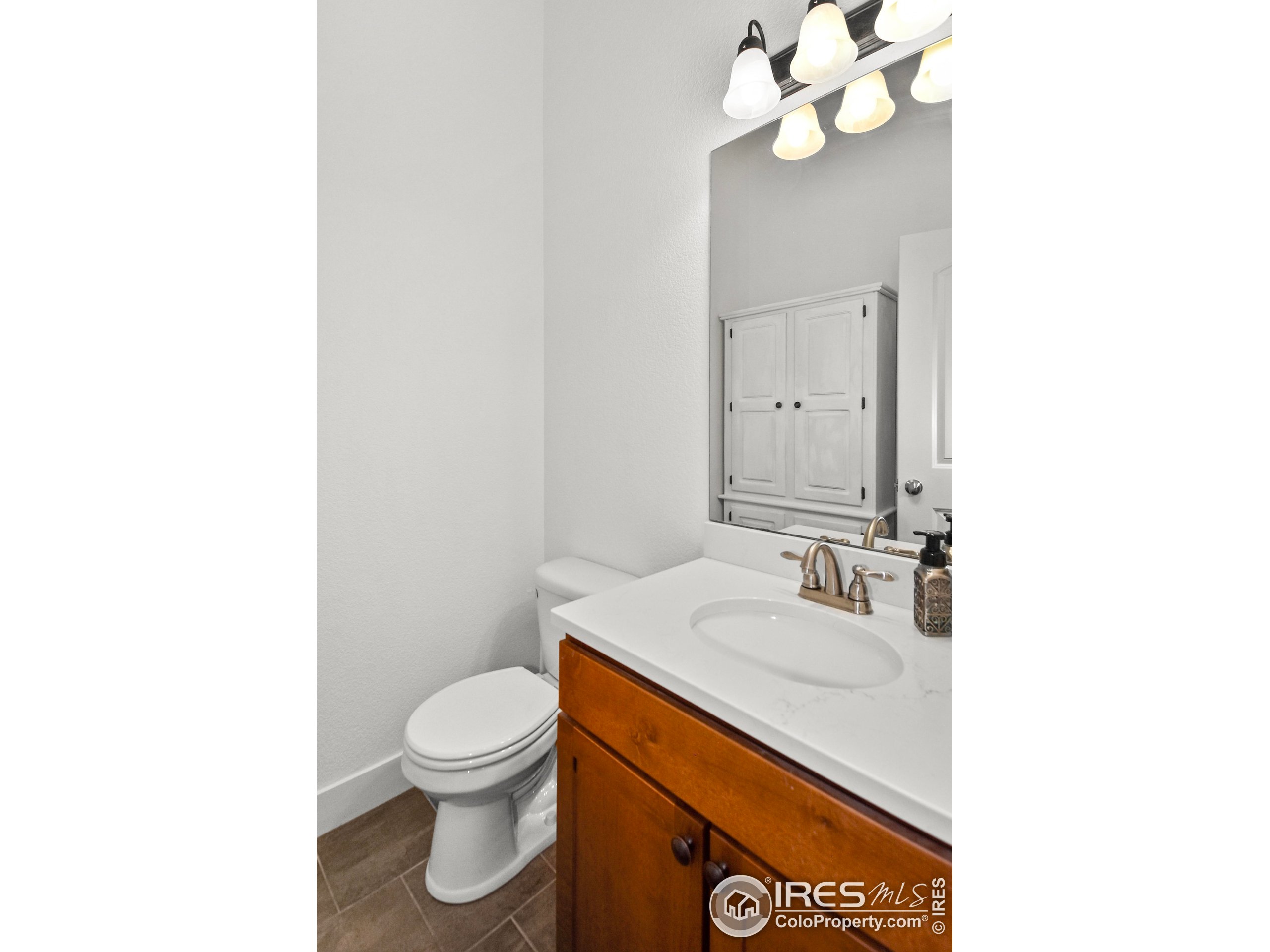 2172 Cape Hatteras Drive, Unit 2 Windsor, CO 80550 - Photo 20 of 46 a bathroom with a sink a toilet and a mirror