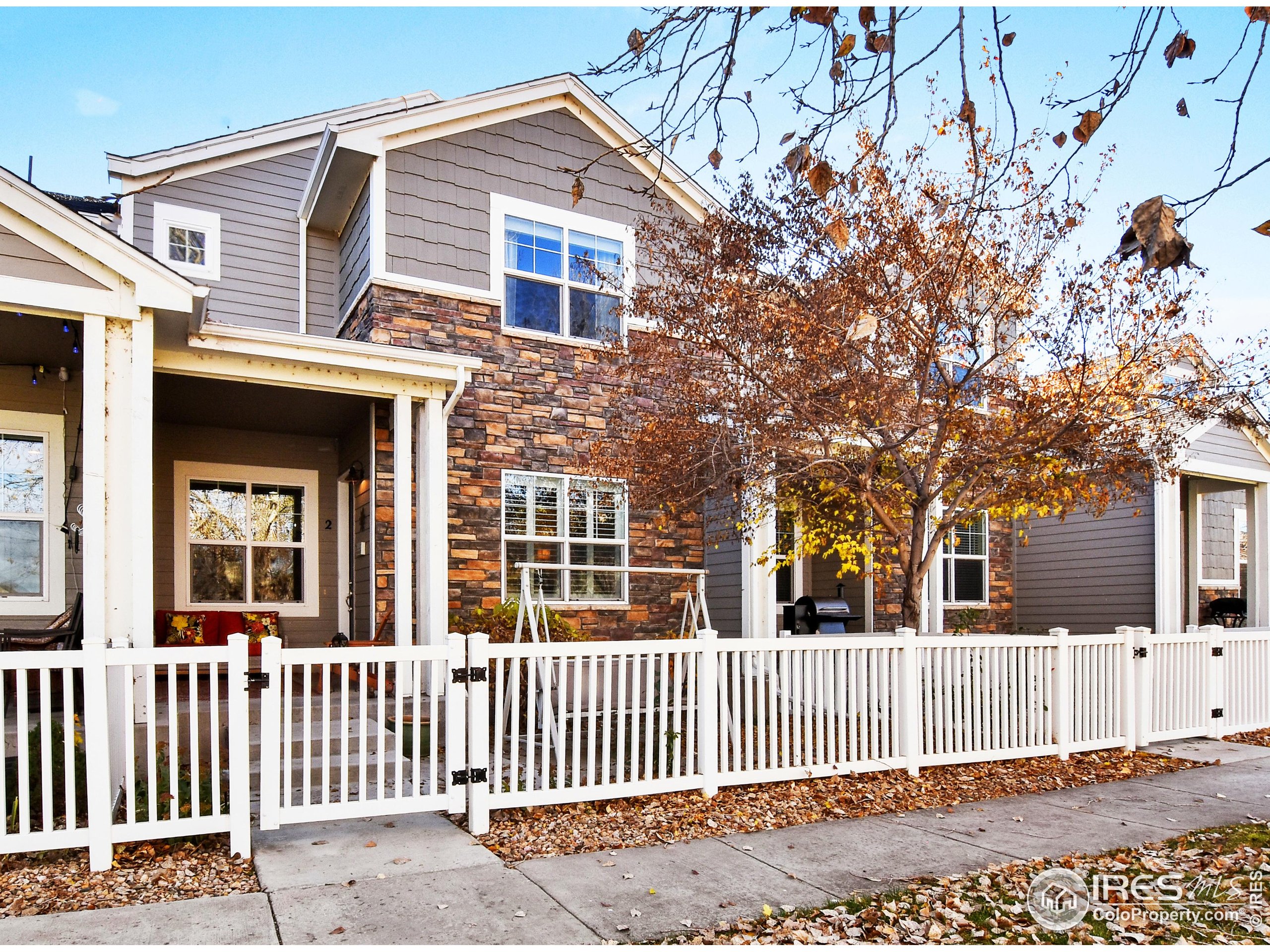 2172 Cape Hatteras Drive, Unit 2 Windsor, CO 80550 - Photo 2 of 46 a front view of a house with a fence