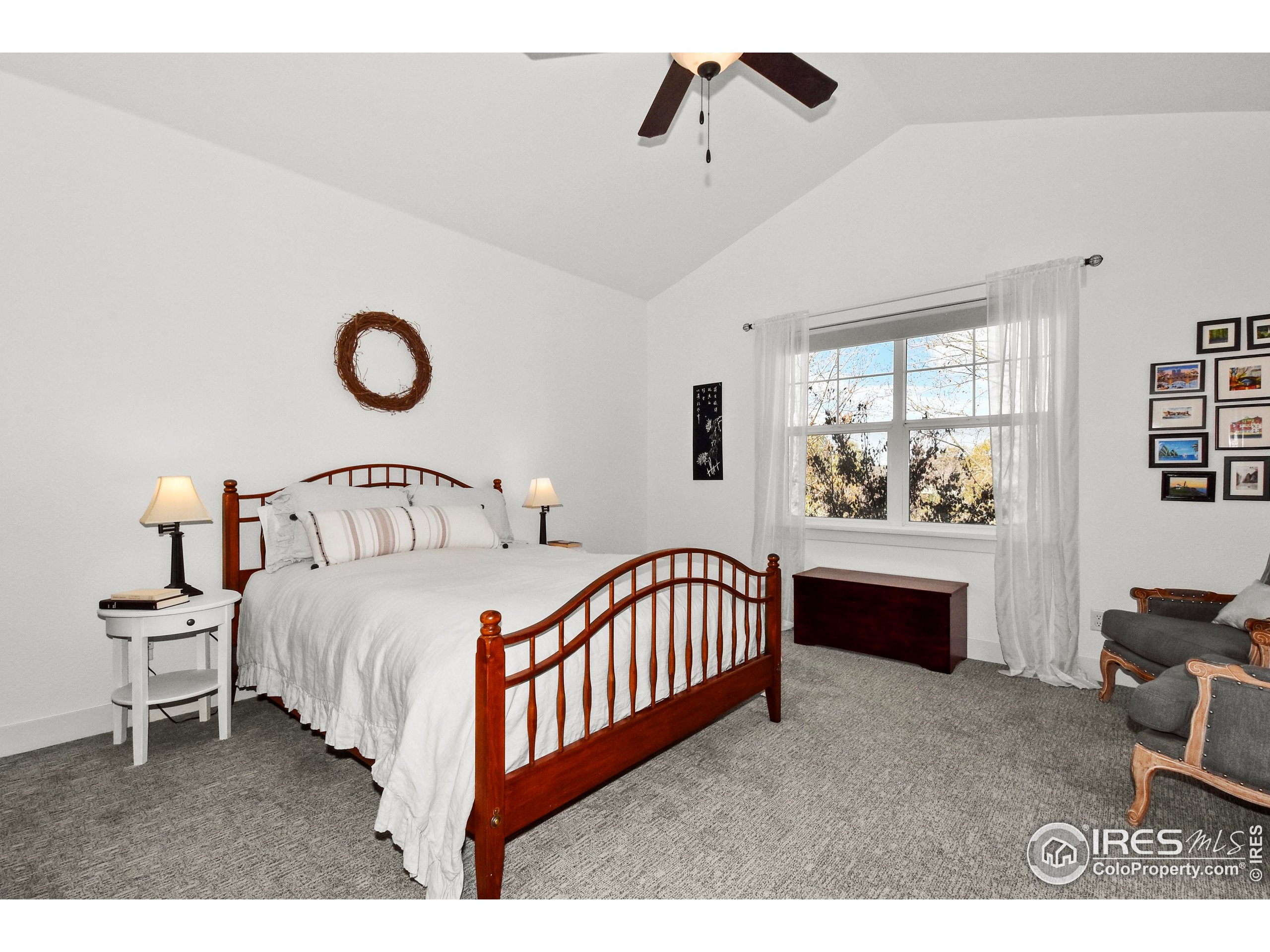 2172 Cape Hatteras Drive, Unit 2 Windsor, CO 80550 - Photo 21 of 46 a bedroom with a bed a chandelier and dresser