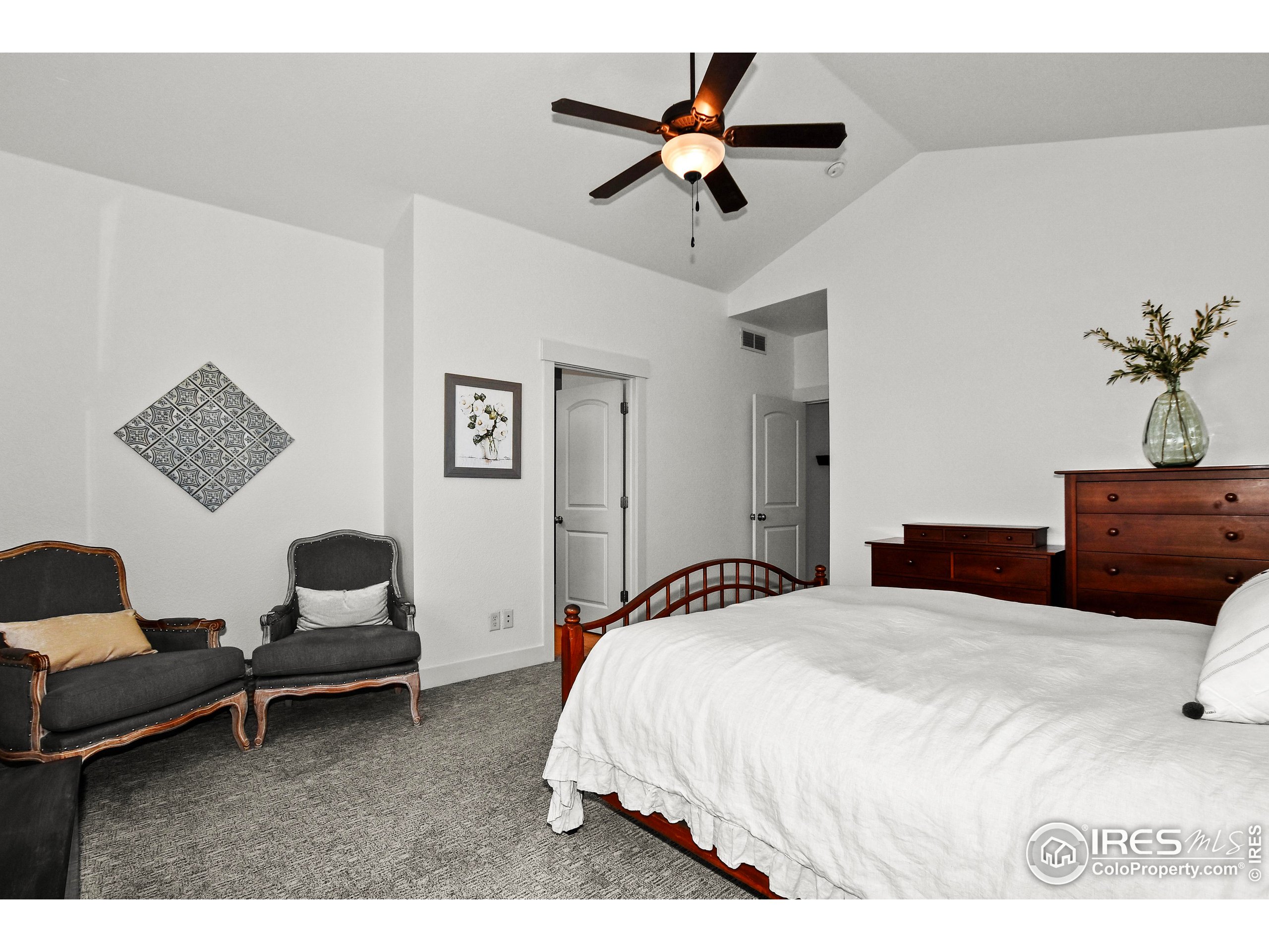 2172 Cape Hatteras Drive, Unit 2 Windsor, CO 80550 - Photo 23 of 46 a bedroom with a bed furniture and a window