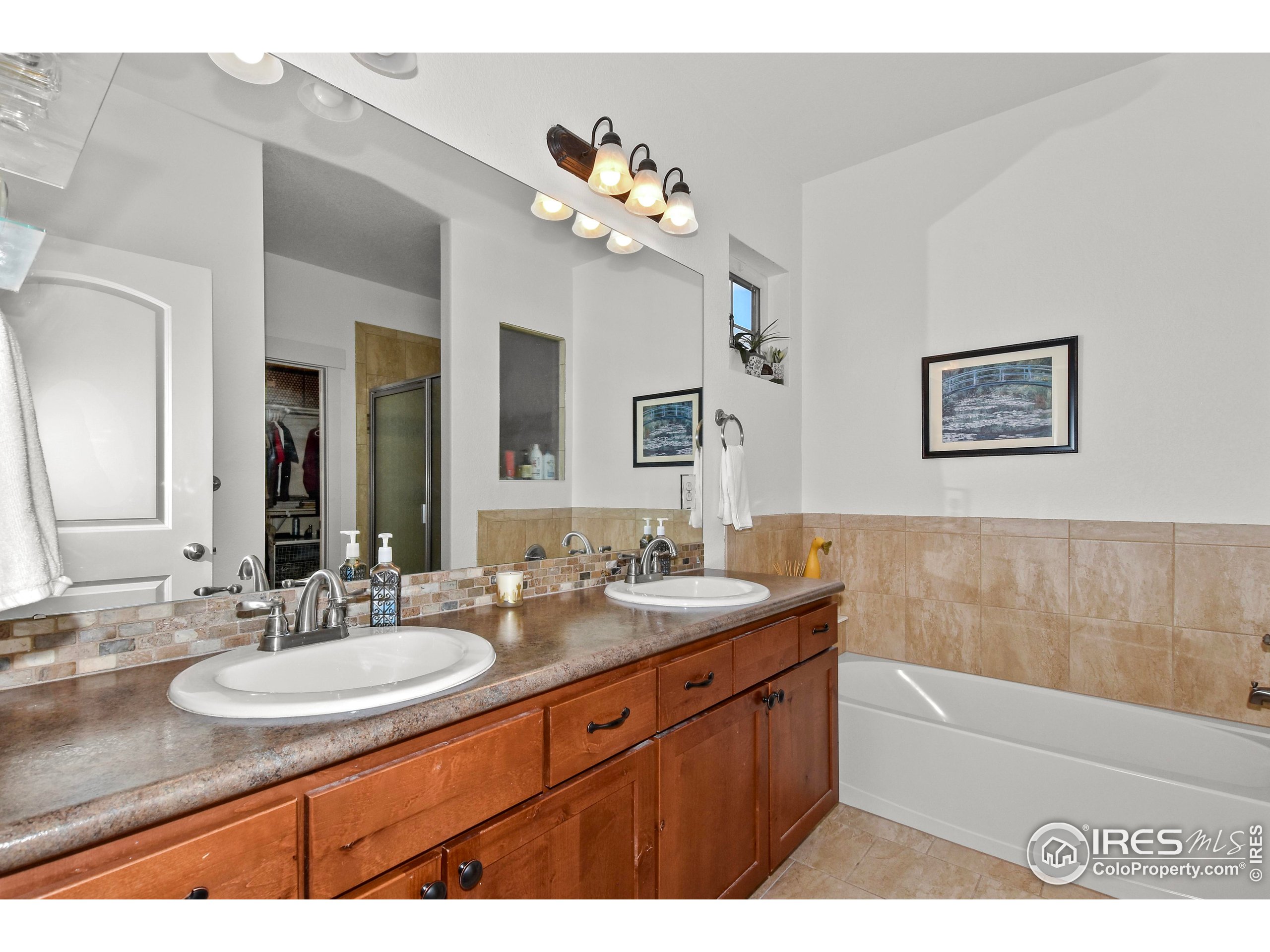 2172 Cape Hatteras Drive, Unit 2 Windsor, CO 80550 - Photo 25 of 46 a bathroom with a sink a vanity and a mirror
