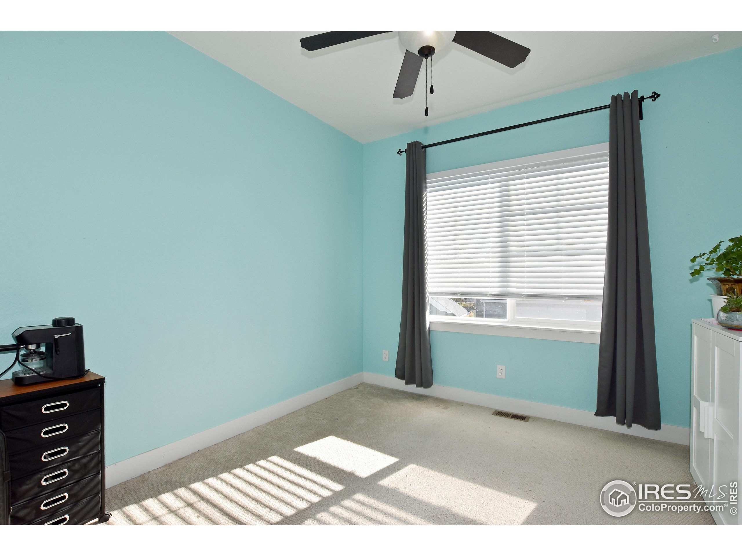 2172 Cape Hatteras Drive, Unit 2 Windsor, CO 80550 - Photo 27 of 46 a view of an empty room with a window