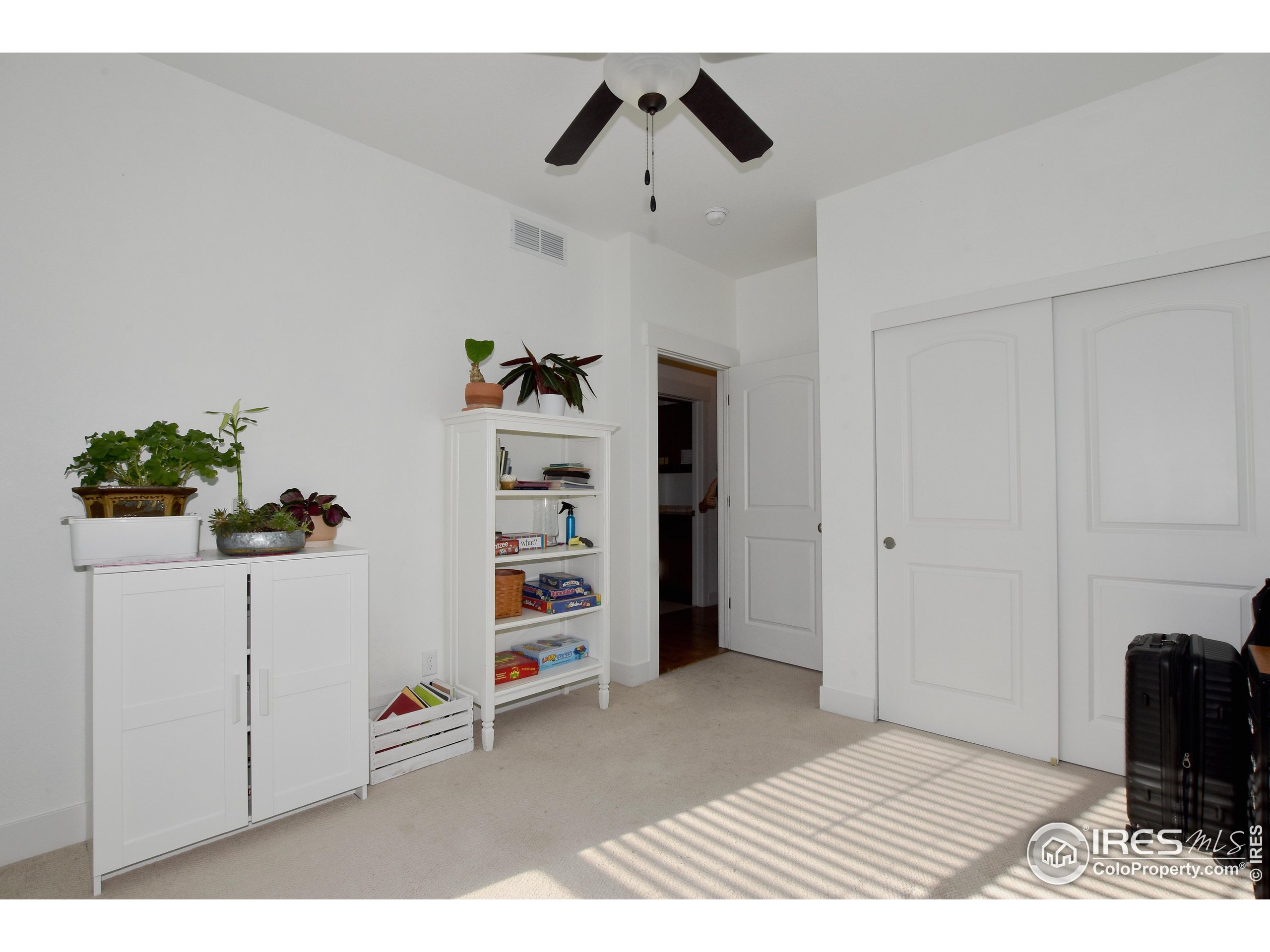 2172 Cape Hatteras Drive, Unit 2 Windsor, CO 80550 - Photo 28 of 46 a view of a bedroom with closet and cabinet