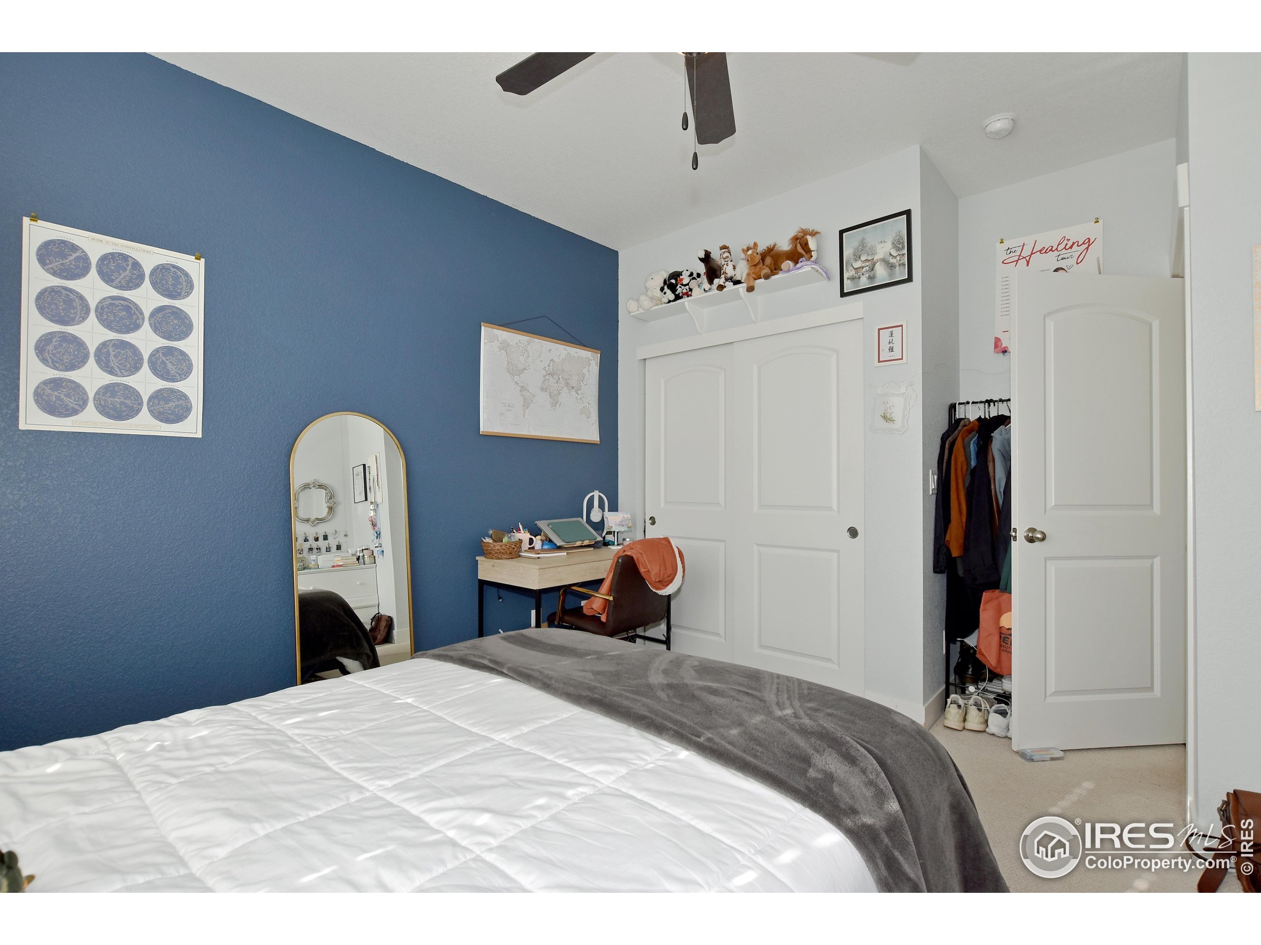 2172 Cape Hatteras Drive, Unit 2 Windsor, CO 80550 - Photo 30 of 46 a bedroom with a bed and a painting on the wall