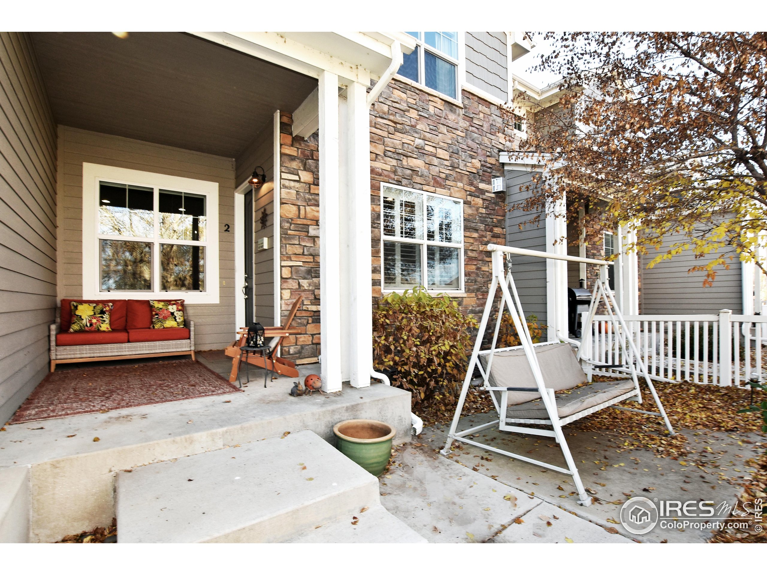 2172 Cape Hatteras Drive, Unit 2 Windsor, CO 80550 - Photo 3 of 46 a view of a chair and table in backyard of the house