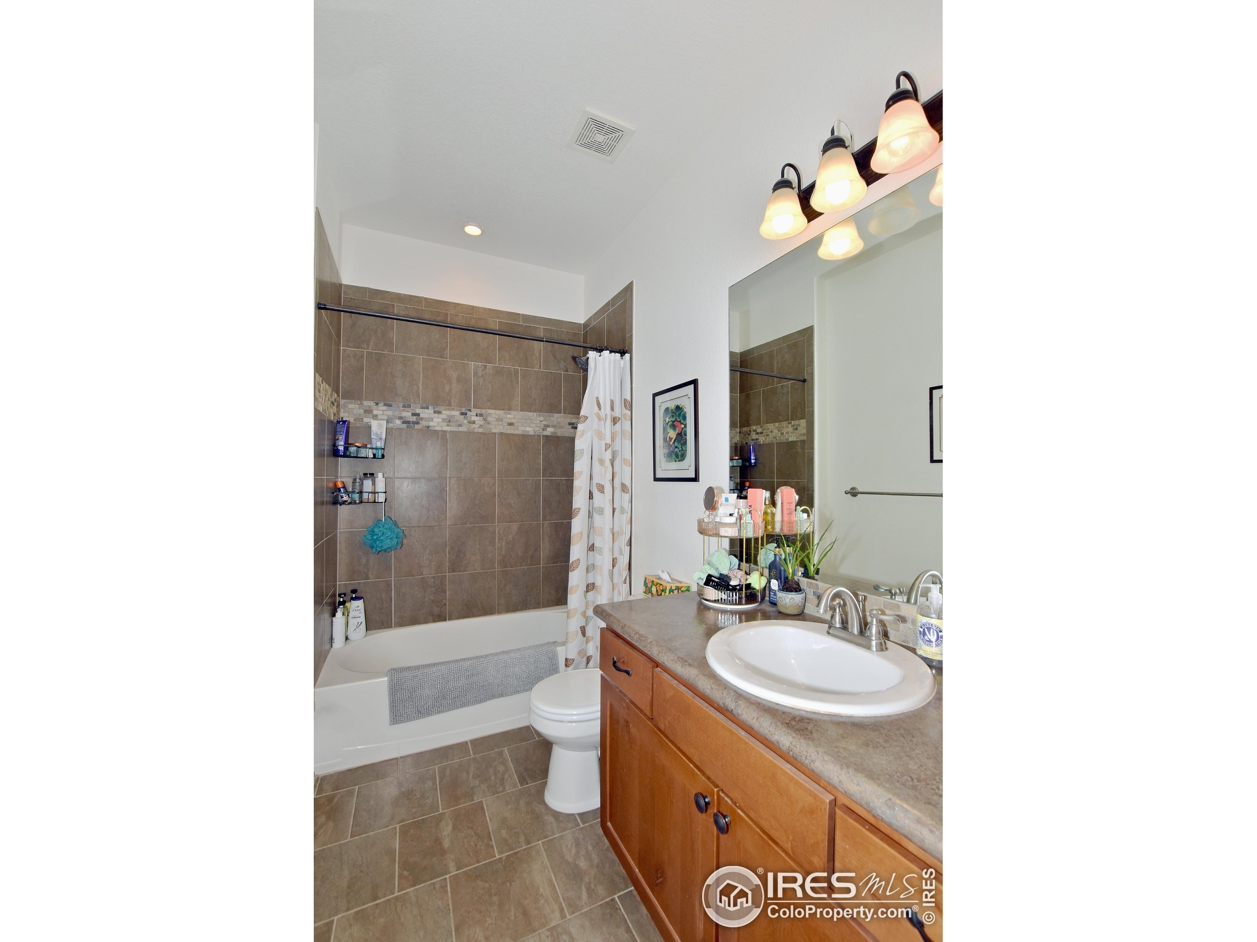 2172 Cape Hatteras Drive, Unit 2 Windsor, CO 80550 - Photo 32 of 46 a bathroom with a sink double vanity granite tub shower and a mirror