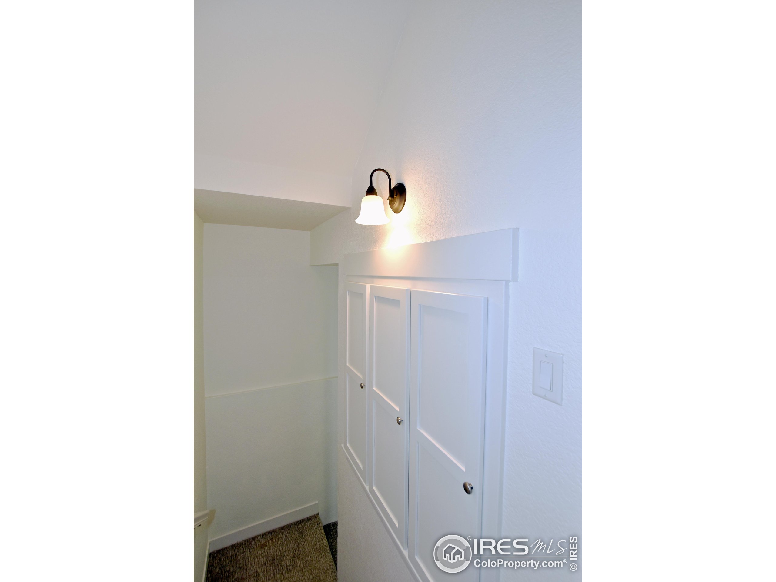 2172 Cape Hatteras Drive, Unit 2 Windsor, CO 80550 - Photo 33 of 46 a view of a room with a white wall and a white wall painting