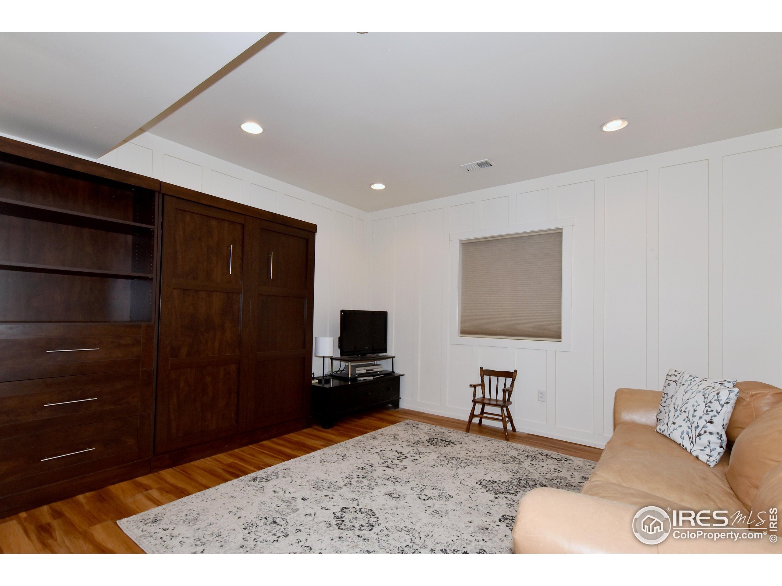 2172 Cape Hatteras Drive, Unit 2 Windsor, CO 80550 - Photo 34 of 46 a living room with a flat screen tv and a fireplace