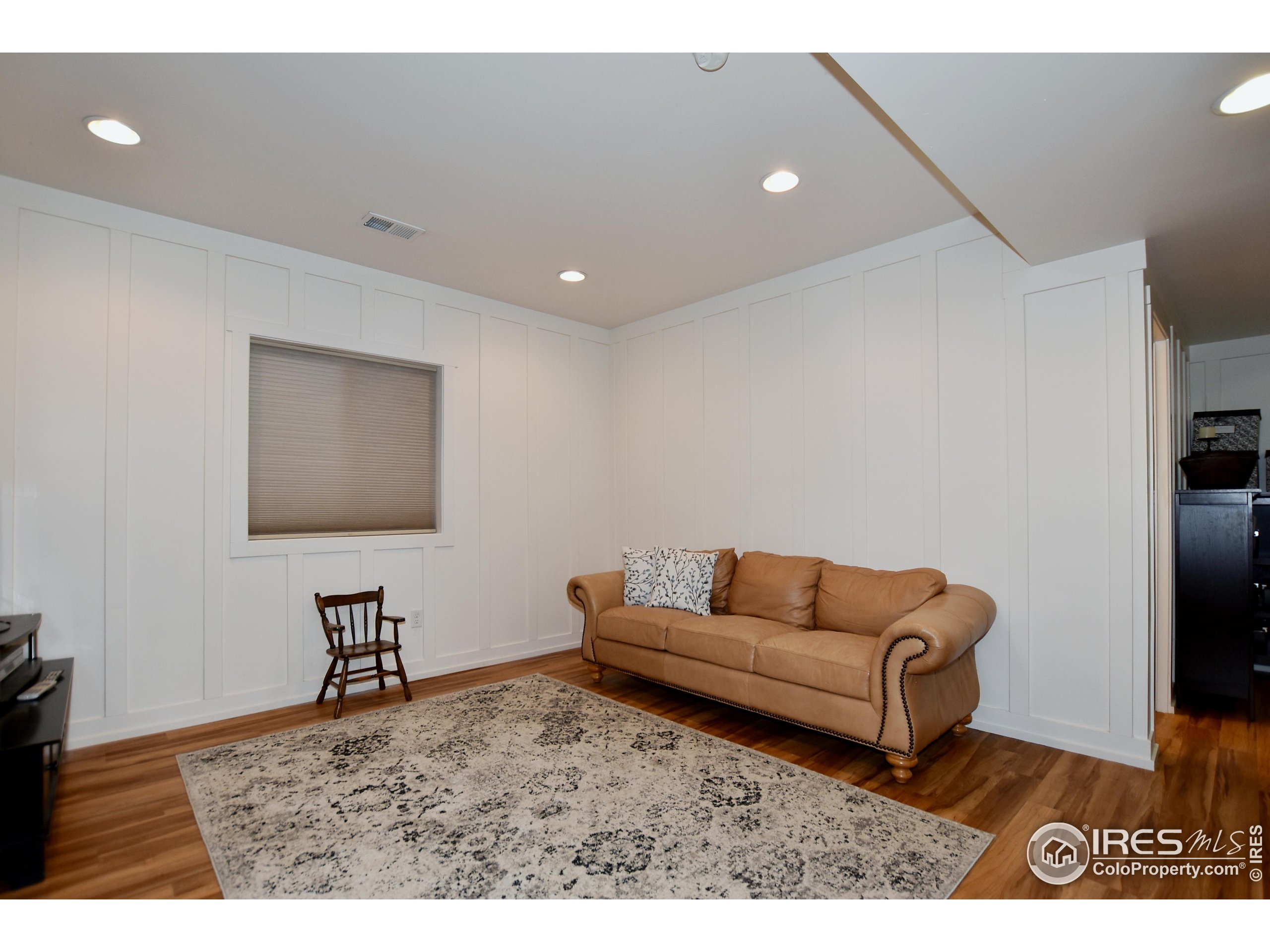 2172 Cape Hatteras Drive, Unit 2 Windsor, CO 80550 - Photo 35 of 46 a living room with furniture and a flat screen tv