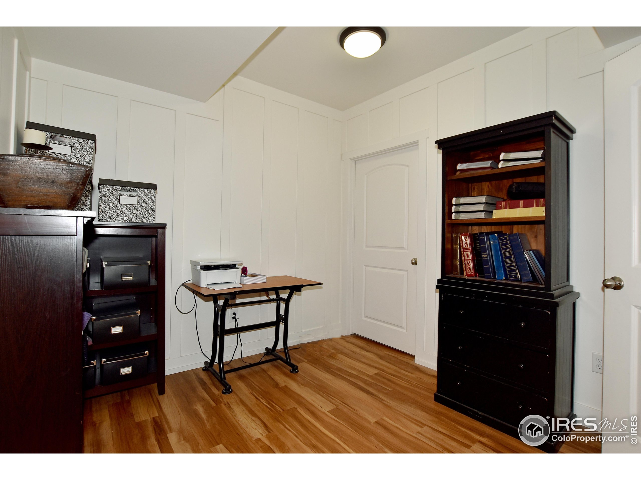 2172 Cape Hatteras Drive, Unit 2 Windsor, CO 80550 - Photo 37 of 46 a living room with furniture and wooden floor