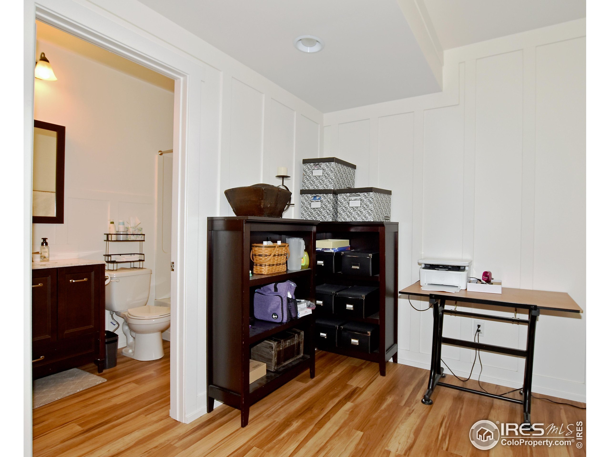 2172 Cape Hatteras Drive, Unit 2 Windsor, CO 80550 - Photo 38 of 46 a living room with furniture and wooden floor