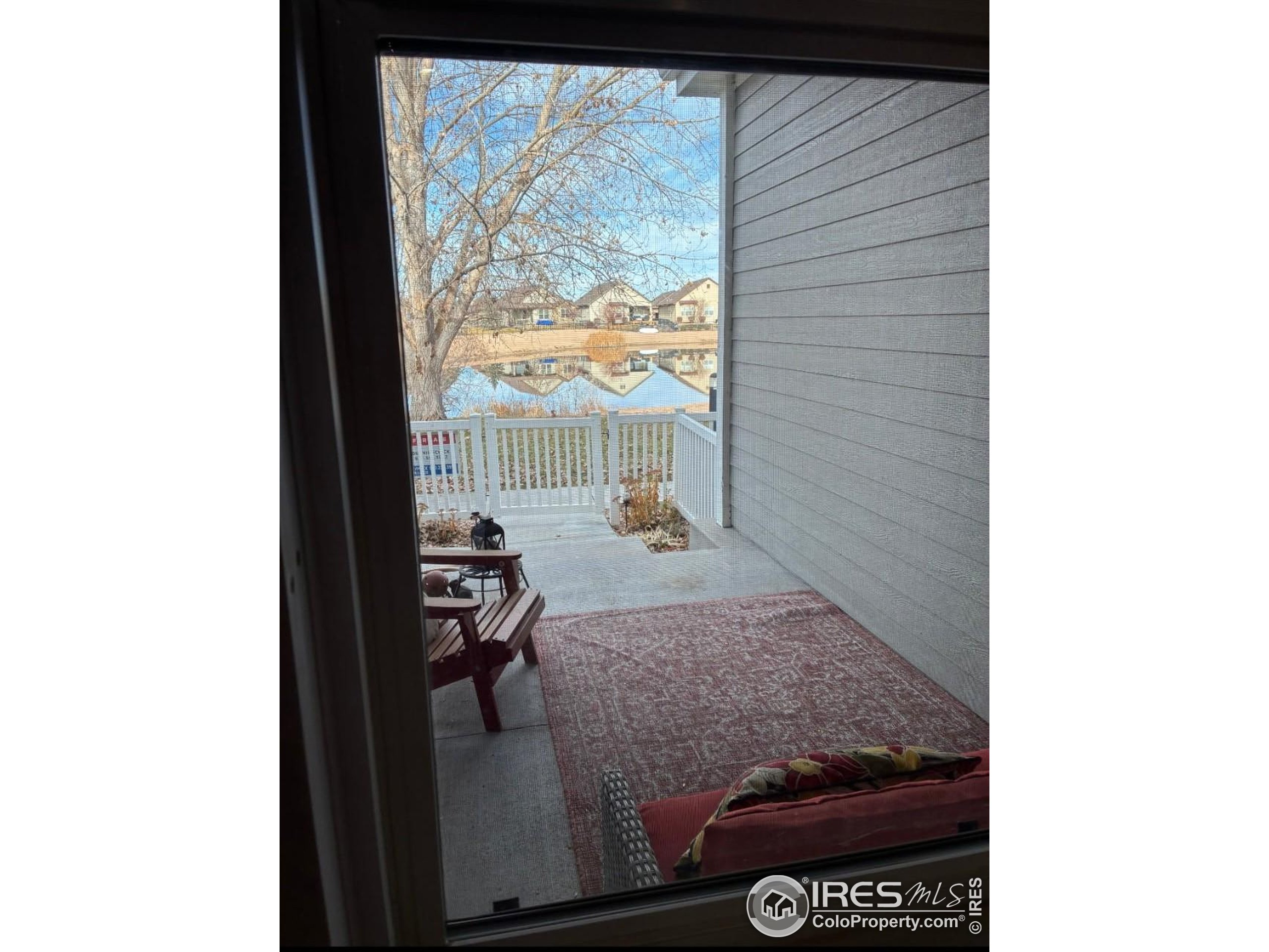 2172 Cape Hatteras Drive, Unit 2 Windsor, CO 80550 - Photo 4 of 46 a living room with furniture and a floor to ceiling window