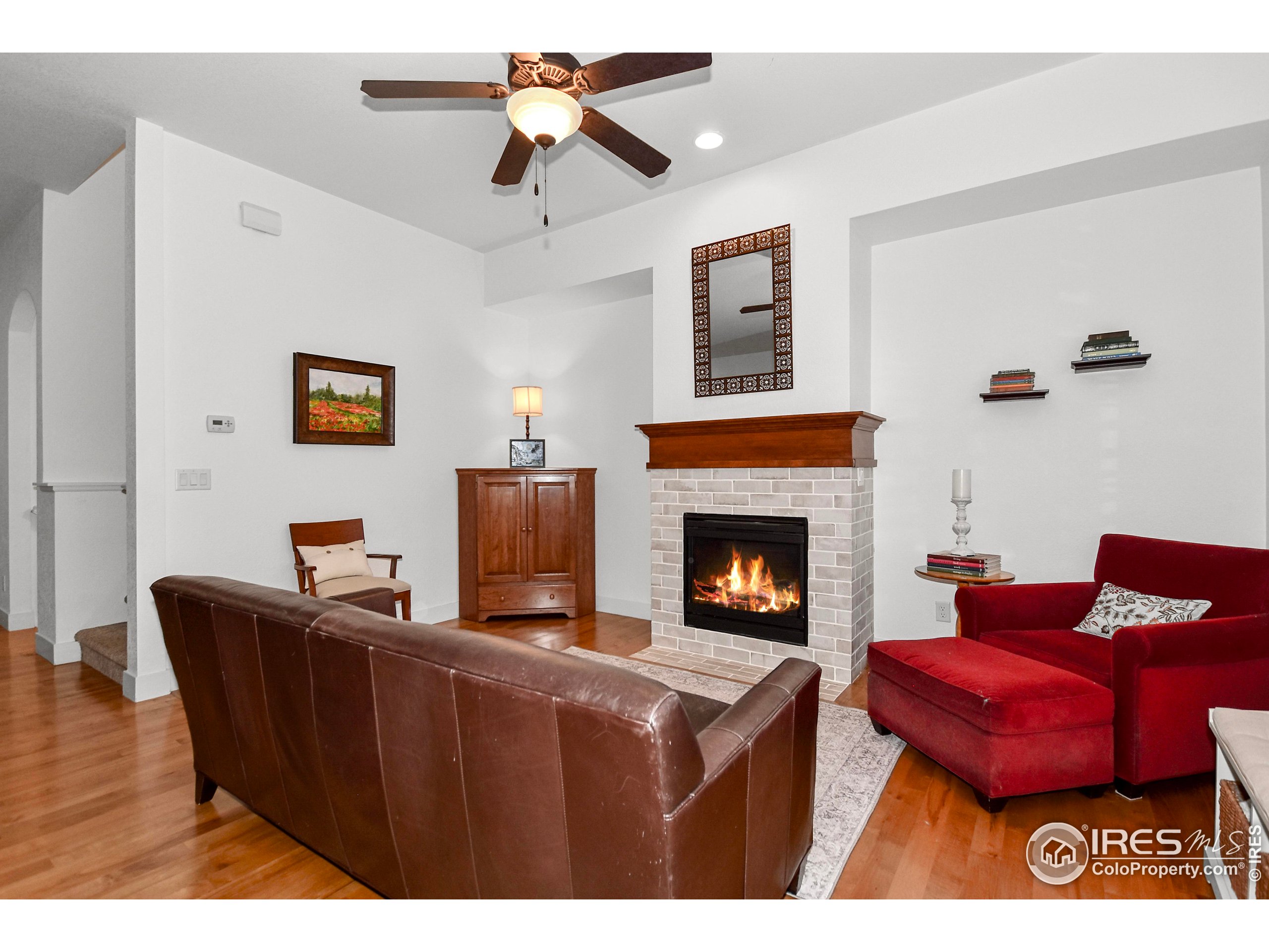 2172 Cape Hatteras Drive, Unit 2 Windsor, CO 80550 - Photo 5 of 46 a living room with furniture a fireplace and a flat screen tv