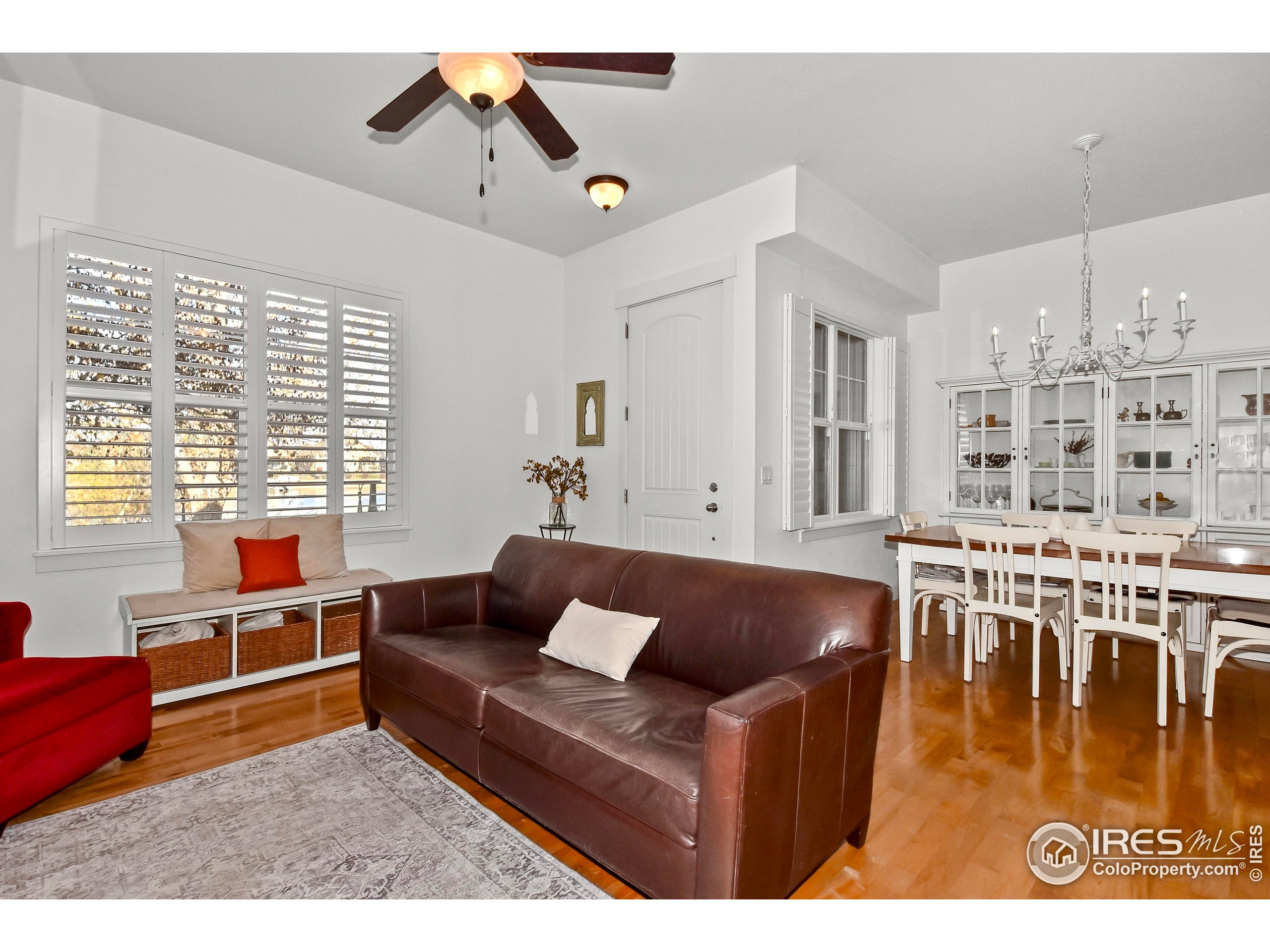 2172 Cape Hatteras Drive, Unit 2 Windsor, CO 80550 - Photo 8 of 46 a living room with furniture wooden floor and a large window