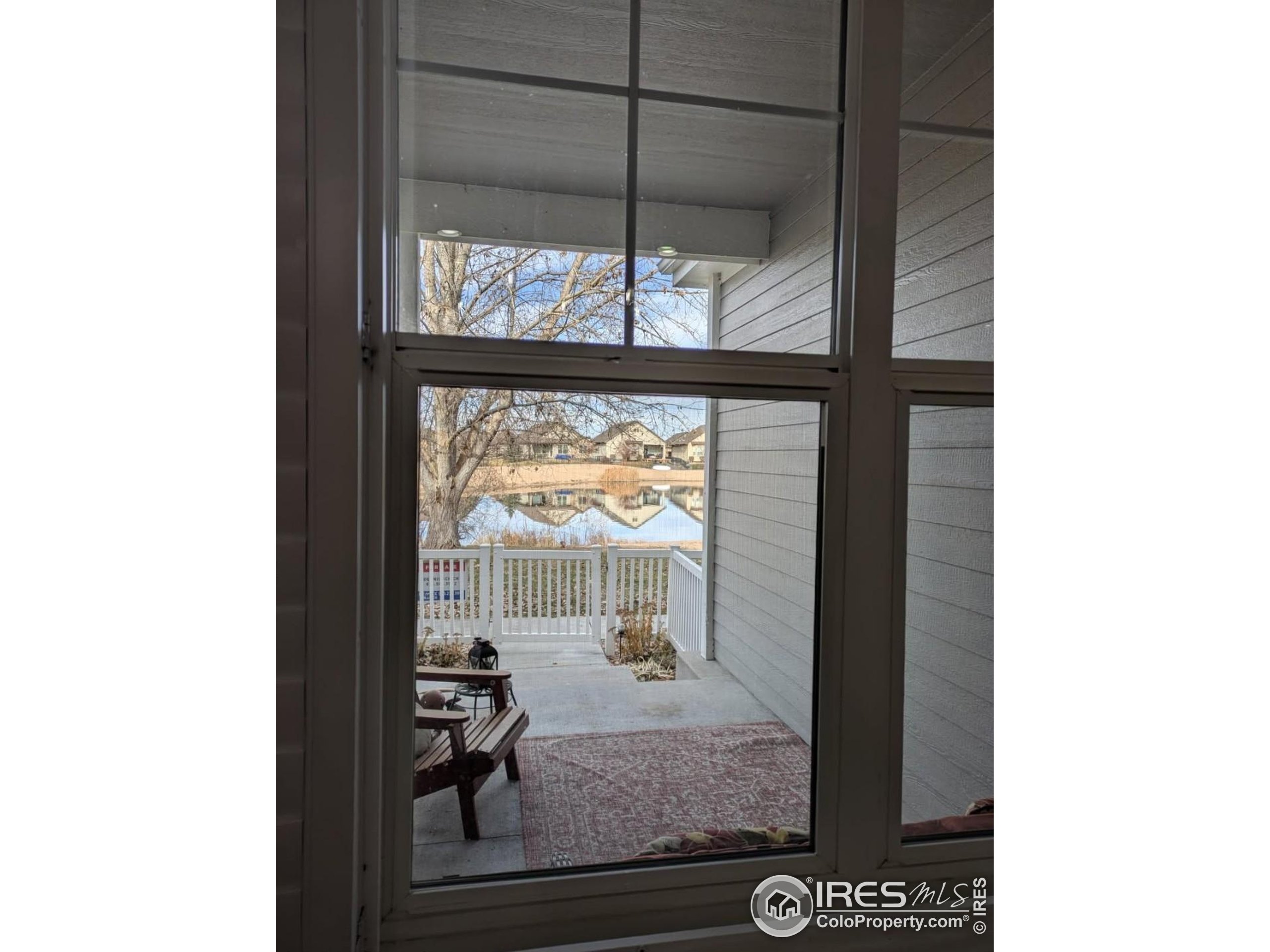 2172 Cape Hatteras Drive, Unit 2 Windsor, CO 80550 - Photo 9 of 46 a view of a room that has a bed and a table in it