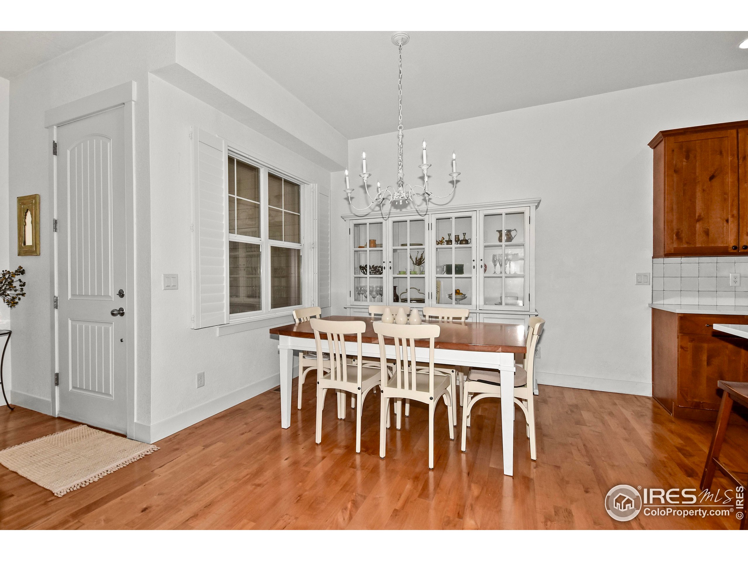 2172 Cape Hatteras Drive, Unit 2 Windsor, CO 80550 - Photo 10 of 46 a view of a dining room with furniture and wooden floor