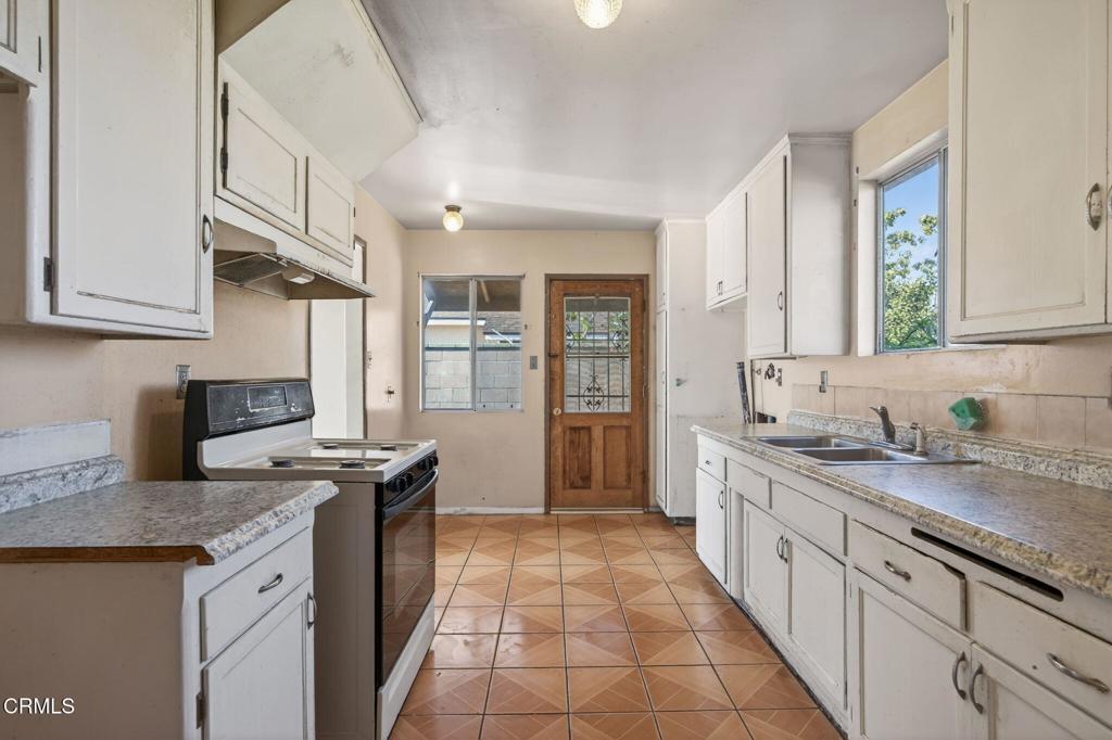 236 East Poplar Street Oxnard, CA 93033 - Photo 3 of 20 a kitchen with stainless steel appliances granite countertop a sink stove and cabinets