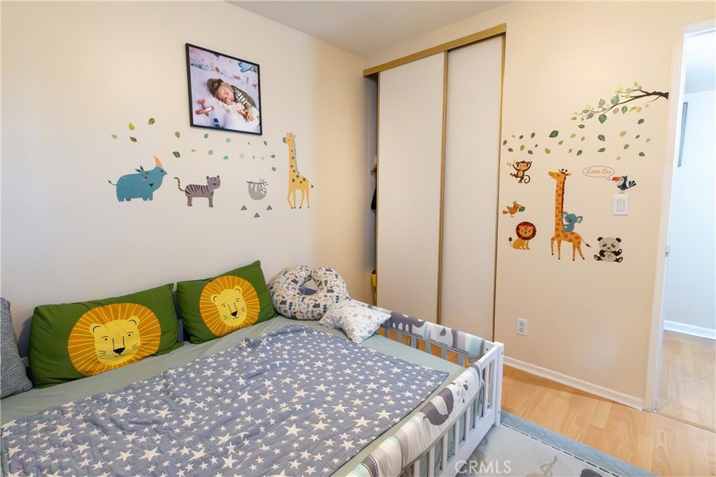 9551 Vía Ricardo Burbank, CA 91504 - Photo 10 of 29 a bedroom with a bed and painting on the wall