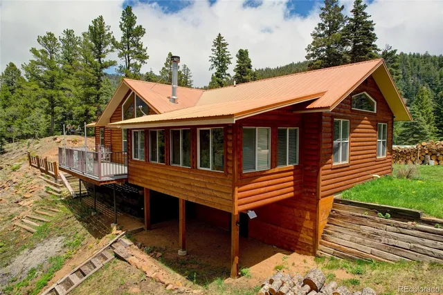 a view of house with a deck and furniture