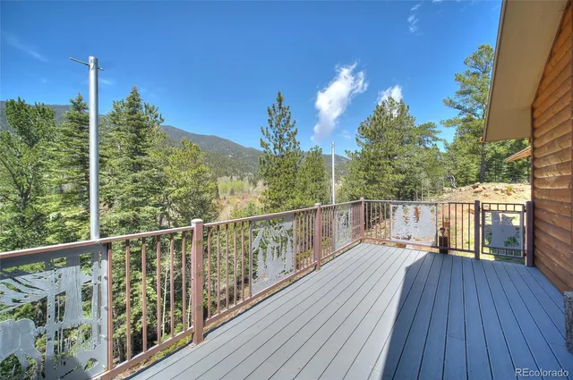 a view of a balcony with wooden floor and fence
