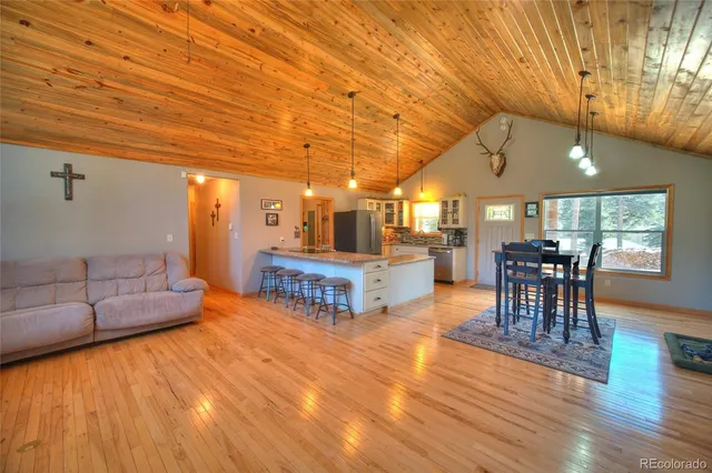 a living room with furniture and kitchen view